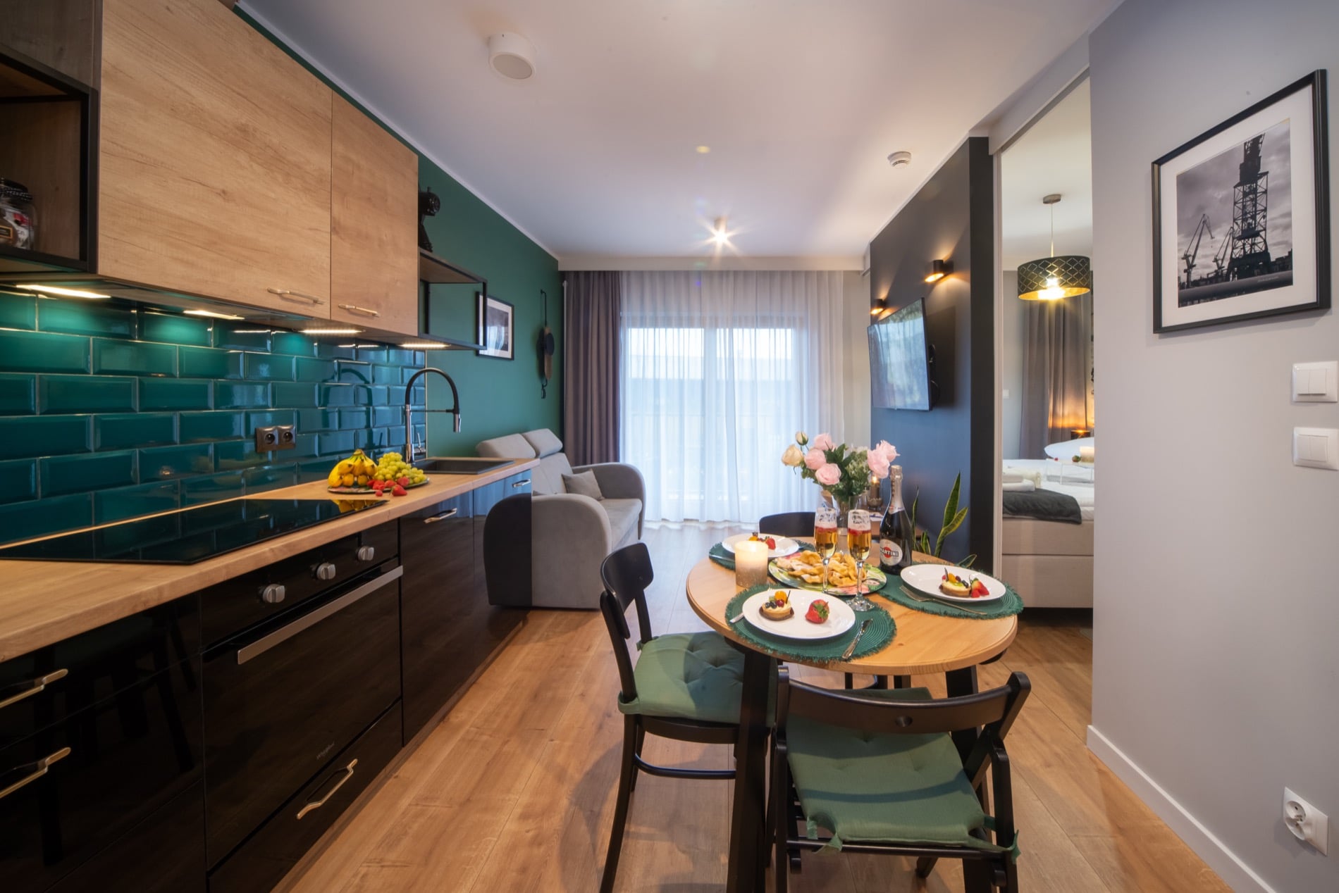 Nad Motławą riverside apartment with teal kitchen and warm wood in Gdańsk — interior view 2