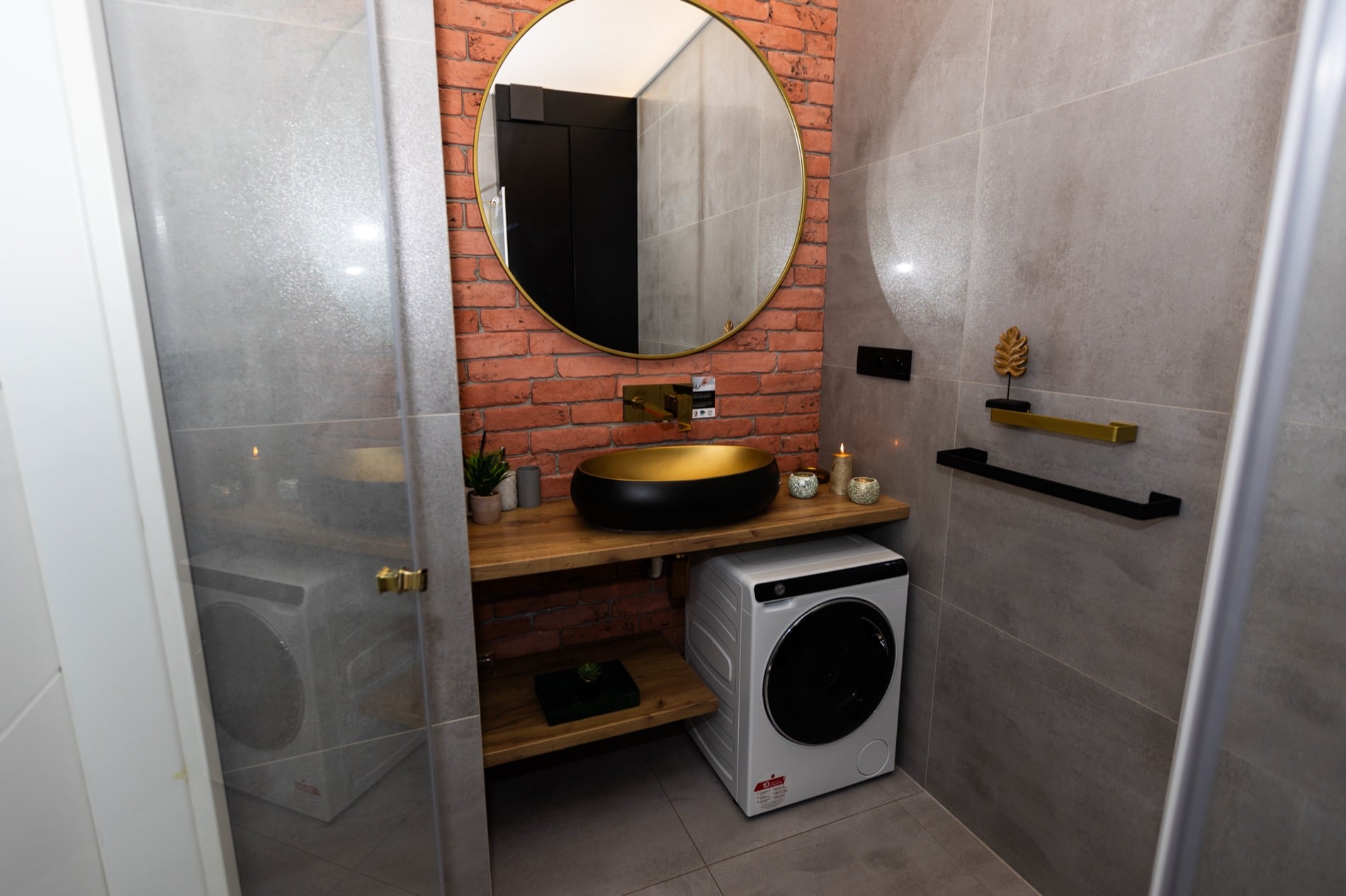 Ogarna Loft with exposed brick and gold accents in Gdańsk Old Town — interior view 4