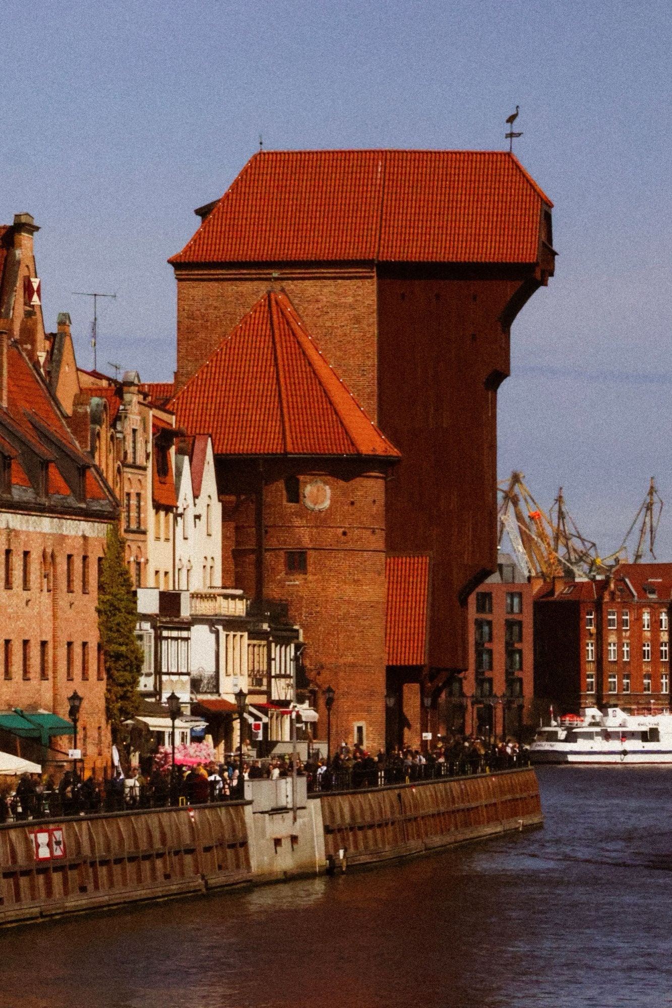 The medieval Crane and the Gothic brick waterfront on the Motława river in Gdańsk.